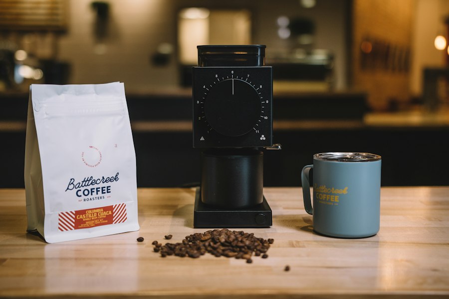 A coffee bag, grinder and mug arranged for a private-label product
